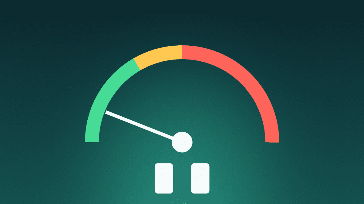 A spam-rate gauge with green, amber and red zones, the needle resting in the green zone above a large pause symbol
